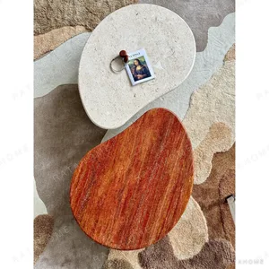 Curved Travertine Coffee Table on Dark Walnut Cylinder Base in oatmeal — in a room setting