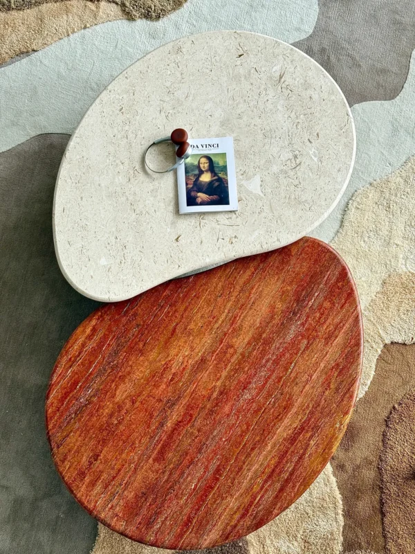 Curved Travertine Coffee Table on Dark Walnut Cylinder Base in oatmeal — in a room setting
