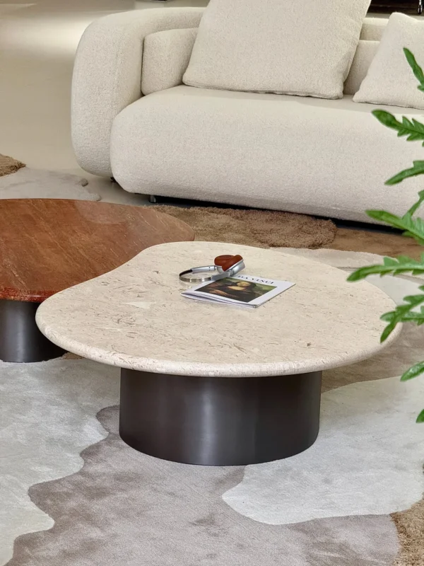 Curved Travertine Coffee Table on Dark Walnut Cylinder Base in oatmeal — in a room setting