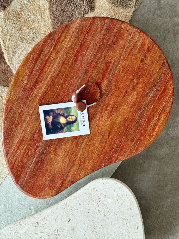 Curved Travertine Coffee Table on Dark Walnut Cylinder Base in oatmeal — in a room setting