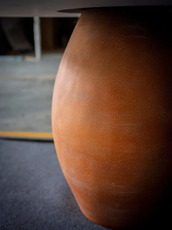 Terracotta Urn-Base Round Dining Table in rust — detail