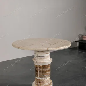 Cream Stone Round Side Table on Layered Onyx Column Base in oatmeal — in a room setting