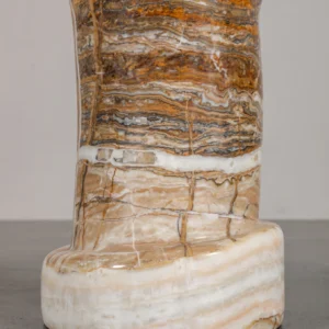 Cream Stone Round Side Table on Layered Onyx Column Base in oatmeal — in a room setting