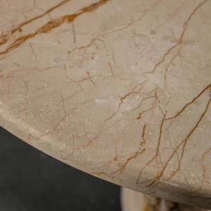 Cream Stone Round Side Table on Layered Onyx Column Base in oatmeal — in a room setting