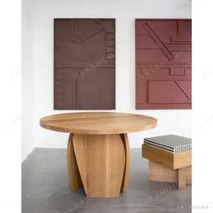 White Oak Round Leisure Table on Curved Panel Base in natural oak — in a room setting