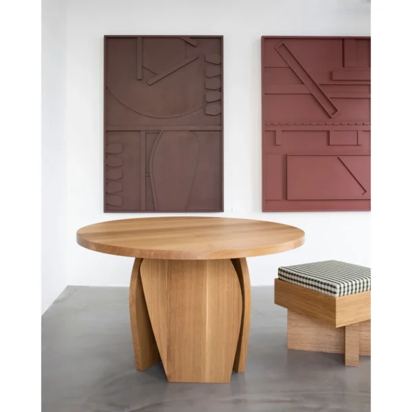 White Oak Round Leisure Table on Curved Panel Base in natural oak — in a room setting