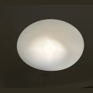 White Saucer Flush Ceiling Light in ivory — in a room setting