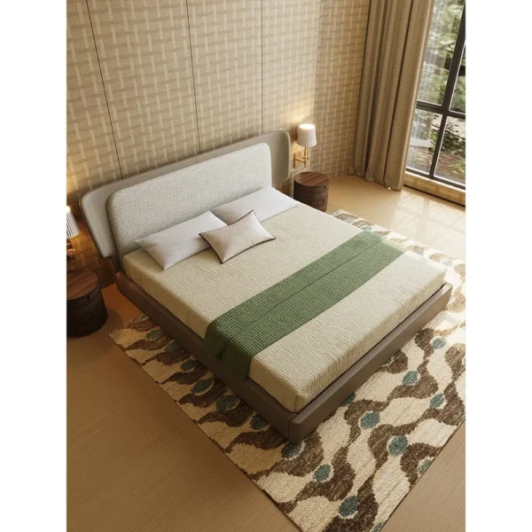 Wide Curved Headboard Bed with Leather Edge in oatmeal — in a room setting
