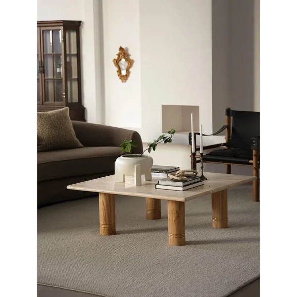 Yellow Travertine Square Coffee Table on Round Legs in sand — in a room setting