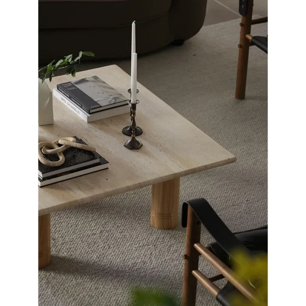 Yellow Travertine Square Coffee Table on Round Legs in sand — in a room setting