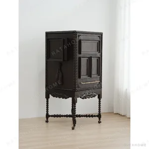 Carved Sequence Cabinet on Barley-Twist Legs with Tassels in black — in a room setting