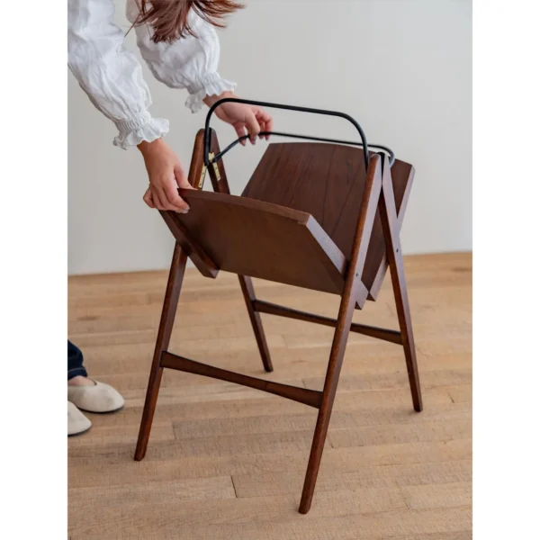 Yuban Folding Wood Side Table with Black Metal Handle in walnut — in a room setting
