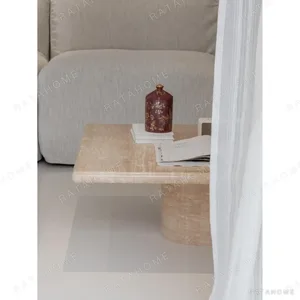 Yuexin Travertine Coffee Table Pair on Cylinder Bases in sand — in a room setting