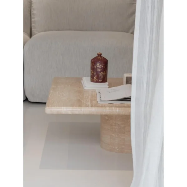 Yuexin Travertine Coffee Table Pair on Cylinder Bases in sand — in a room setting
