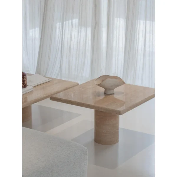 Yuexin Travertine Coffee Table Pair on Cylinder Bases in sand — in a room setting