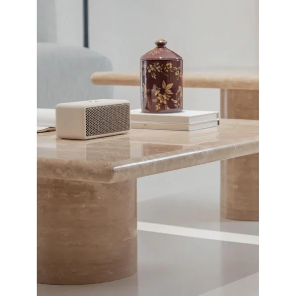 Yuexin Travertine Coffee Table Pair on Cylinder Bases in sand — in a room setting