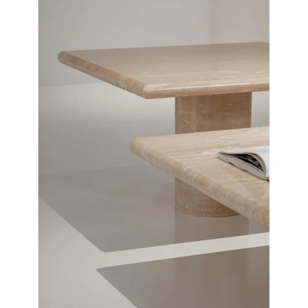 Yuexin Travertine Coffee Table Pair on Cylinder Bases in sand — in a room setting