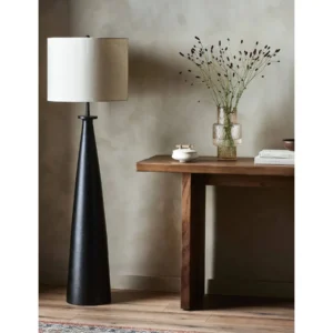 Zakai Black Iron Cone Floor Lamp with Off-White Drum Shade in black — in a room setting