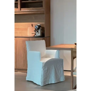 White Slipcovered Dining Armchair in ivory — in a room setting