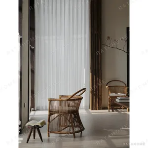 Natural Rattan Armchair with Suspended Back in natural oak — in a room setting