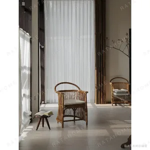 Natural Rattan Armchair with Suspended Back in natural oak — in a room setting