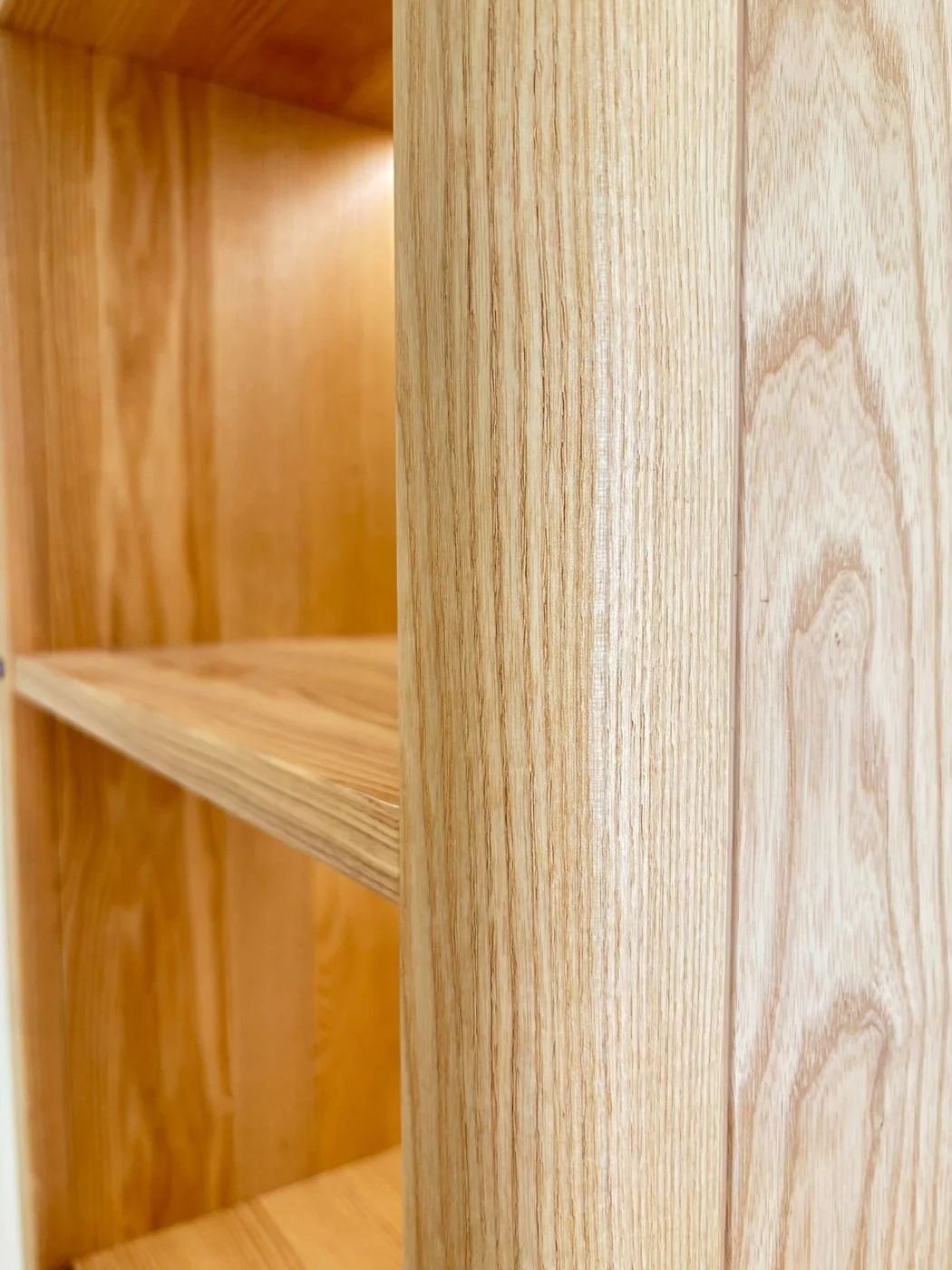 Close-up of ash cabinetry edge and vertical grain