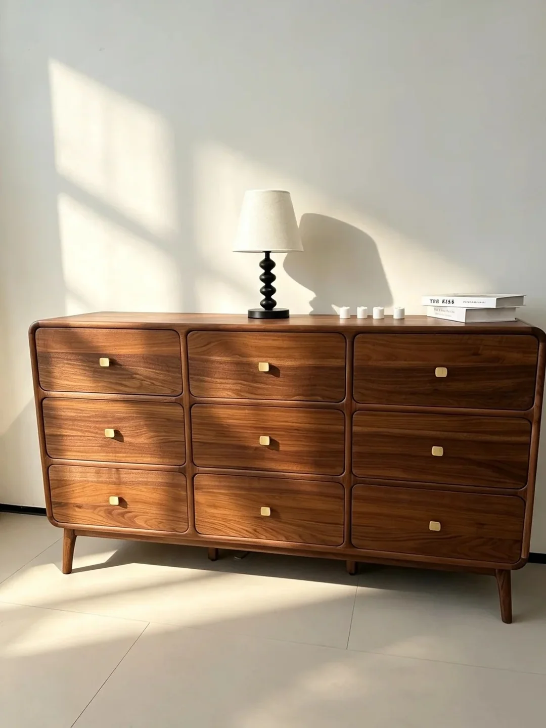 Rounded walnut dresser with nine drawers and brass pulls