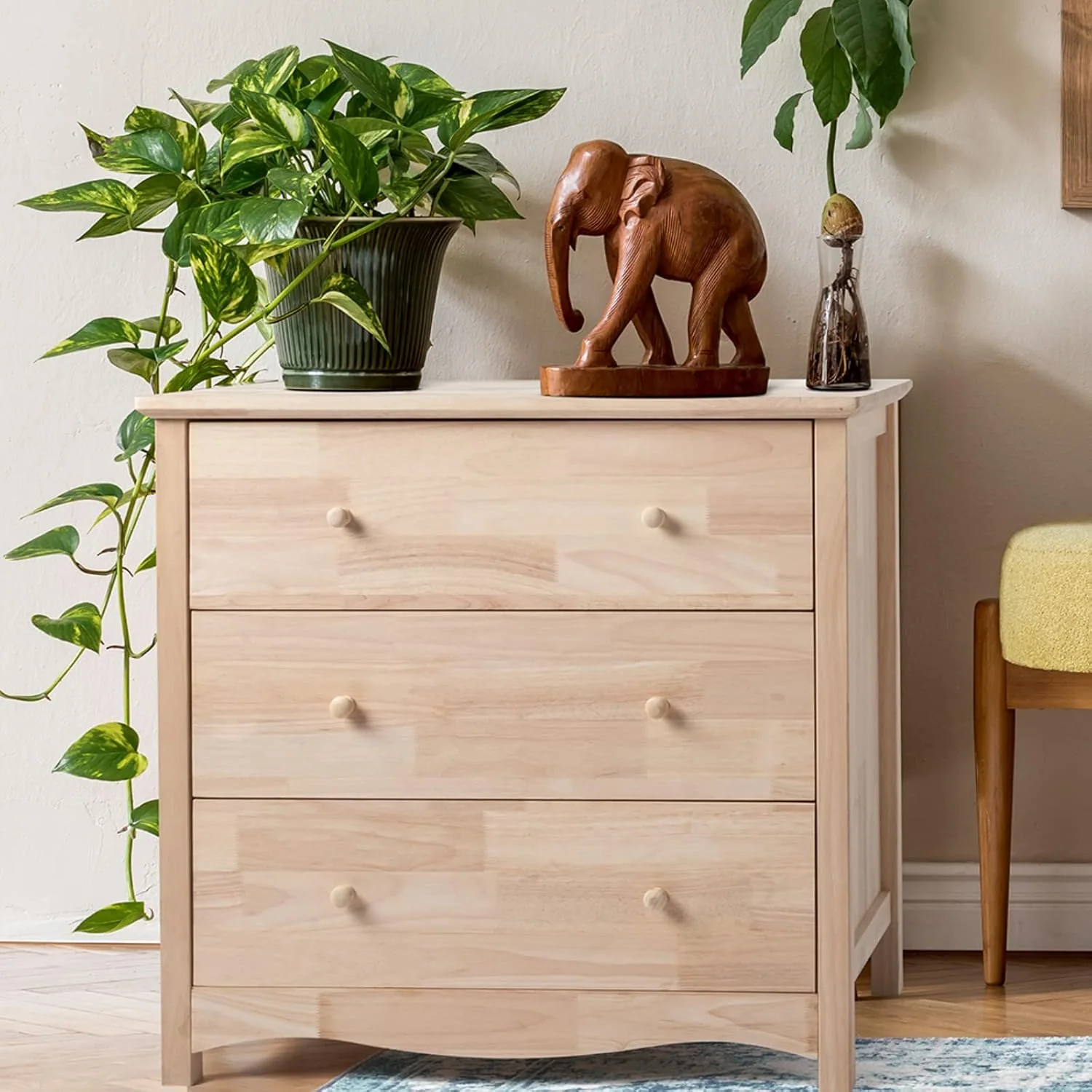 Light rubberwood three-drawer dresser in a residential interior
