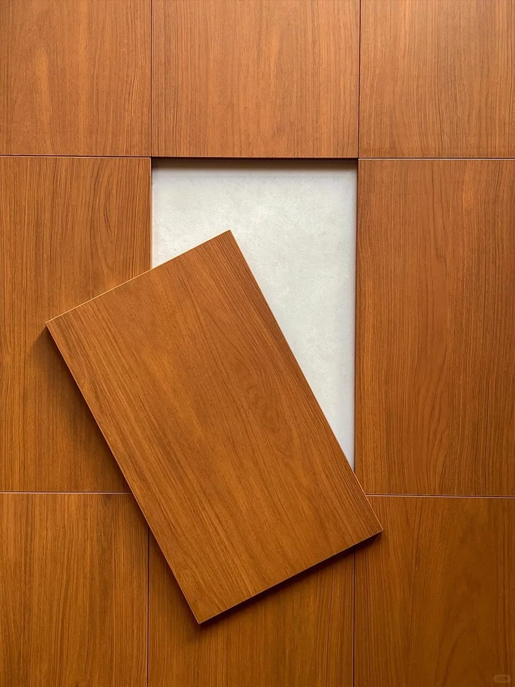 Teak wood sample board showing warm golden-brown tone and fine grain