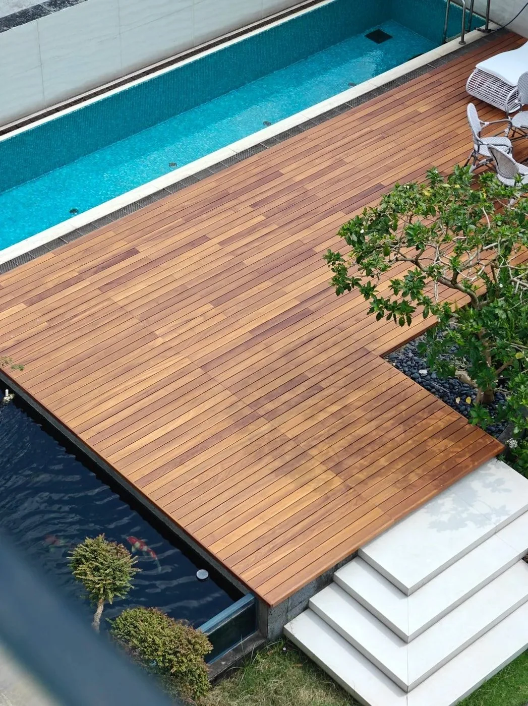 Teak decking beside a swimming pool
