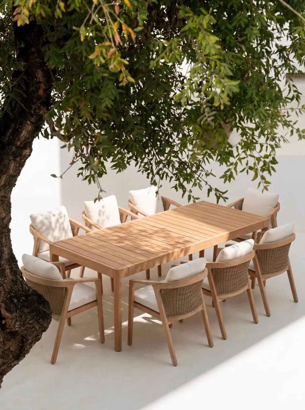 Teak outdoor dining furniture set under a tree