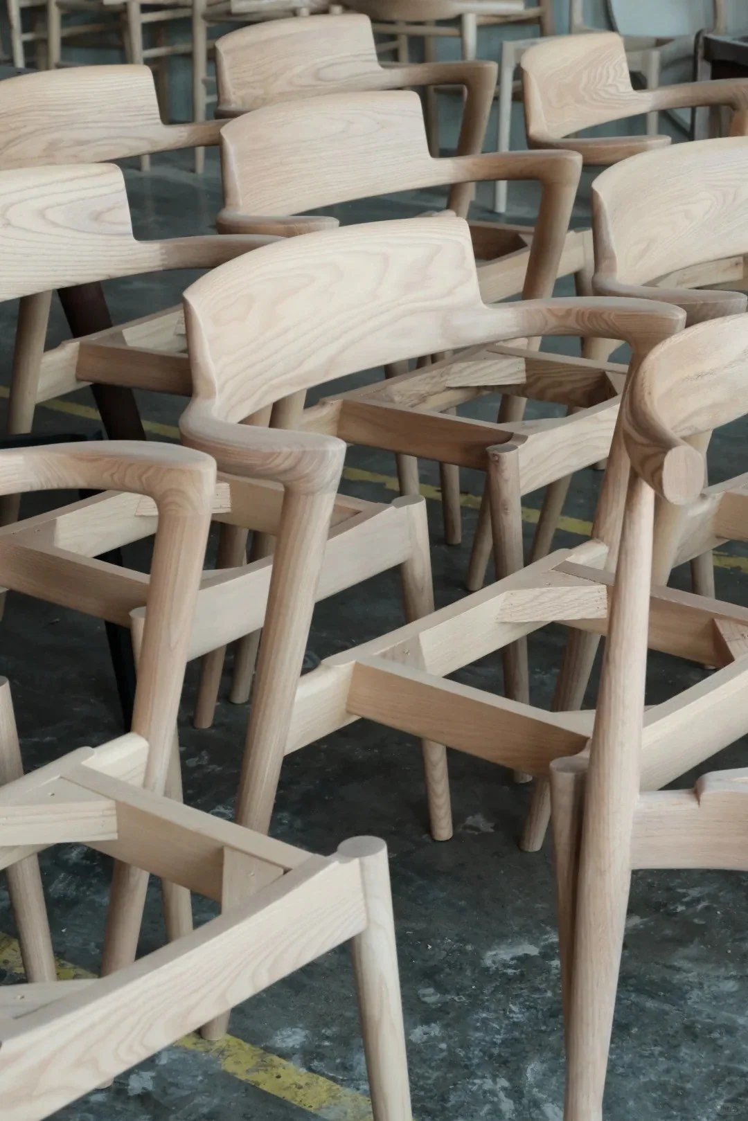 Unfinished light wood chair frames during production