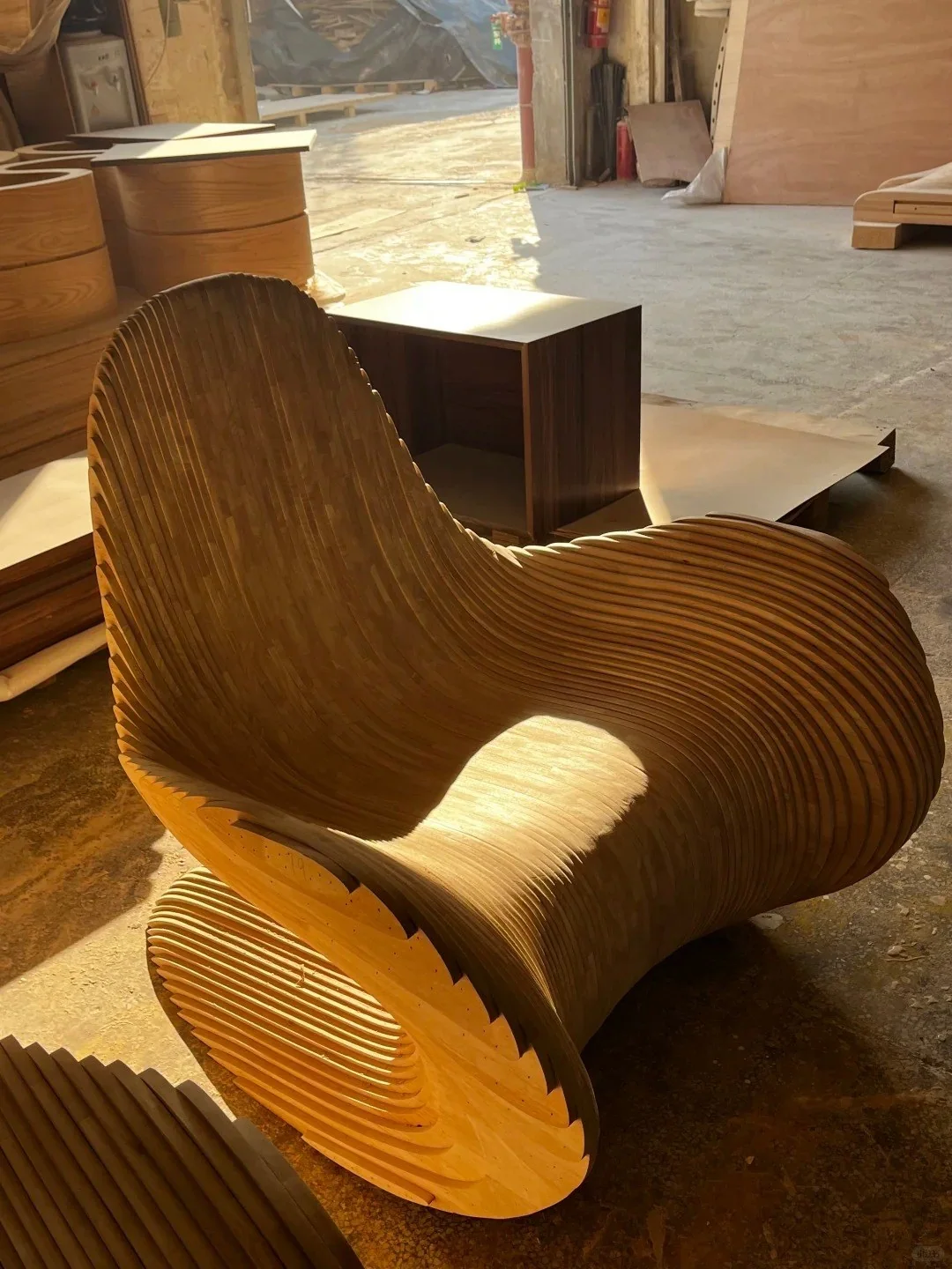 Complex laminated wood lounge chair in a furniture workshop