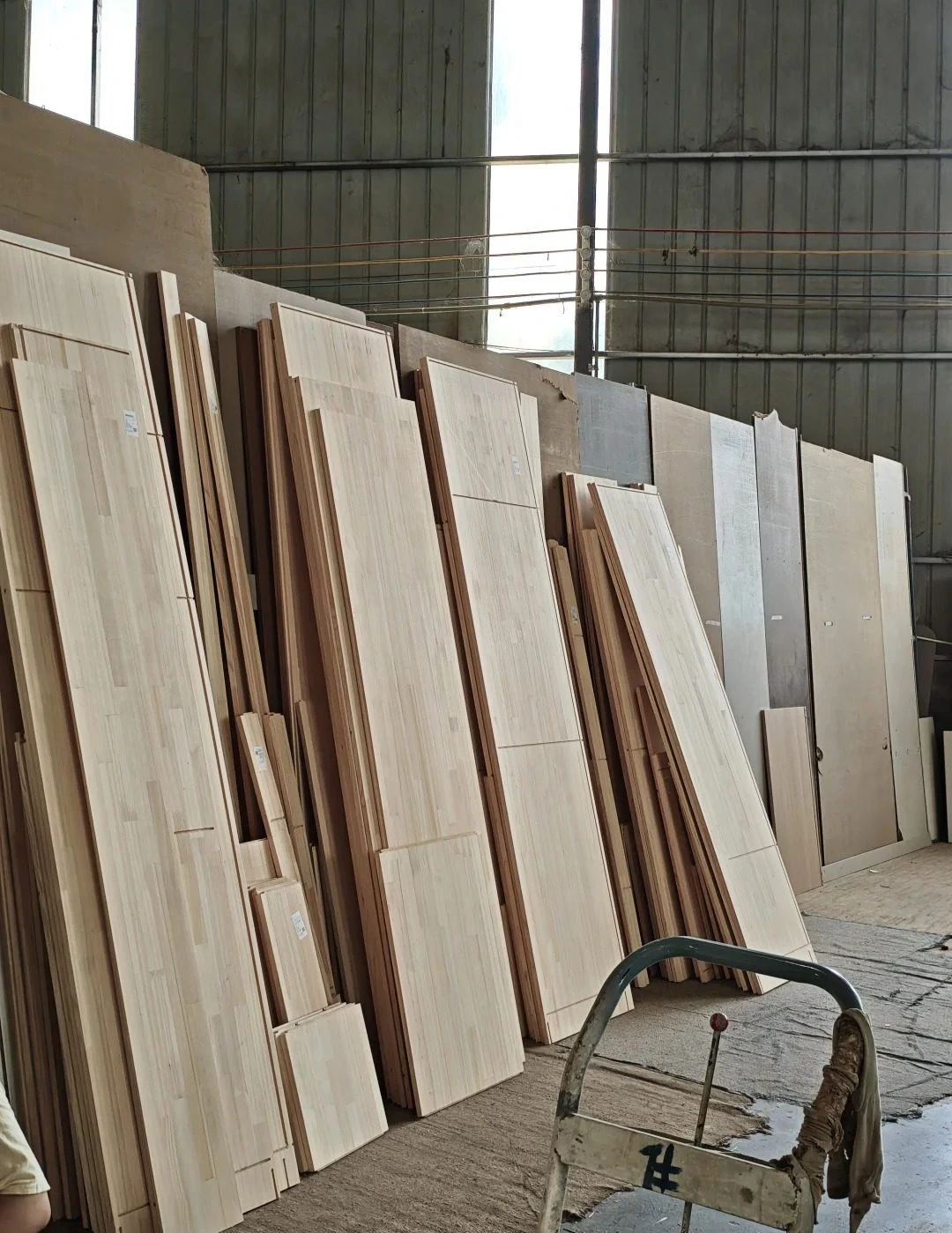 Solid wood cabinet panel components organized in a factory