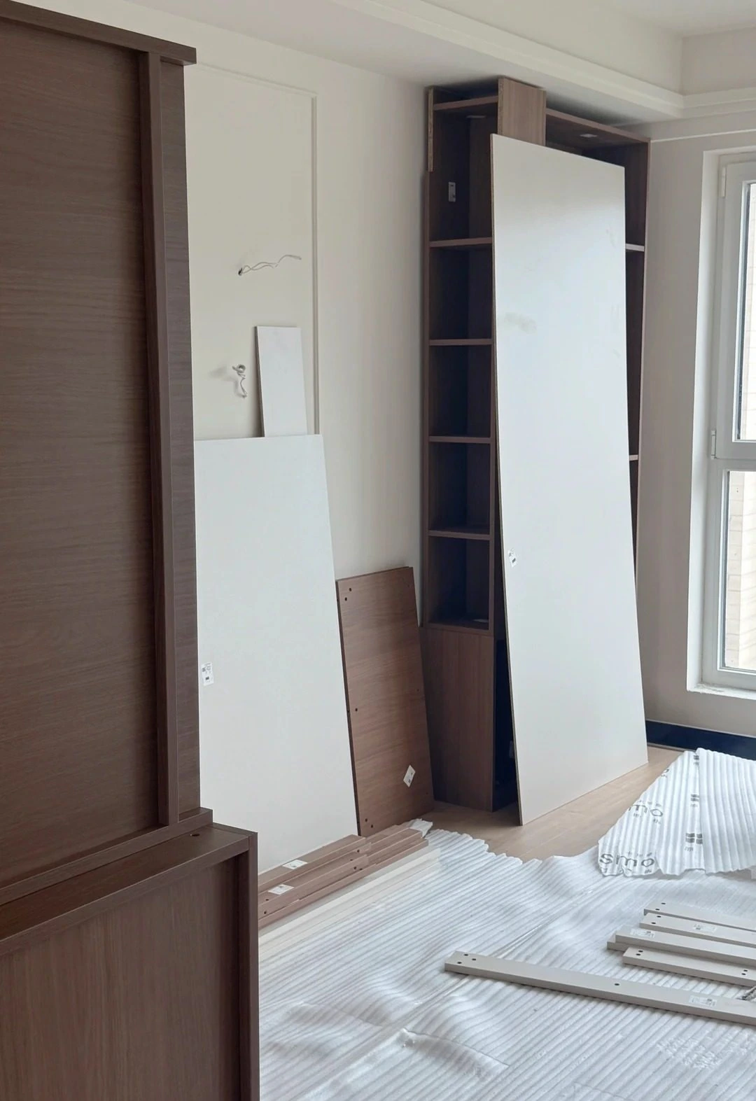 Tall cabinet panels and parts prepared for site assembly