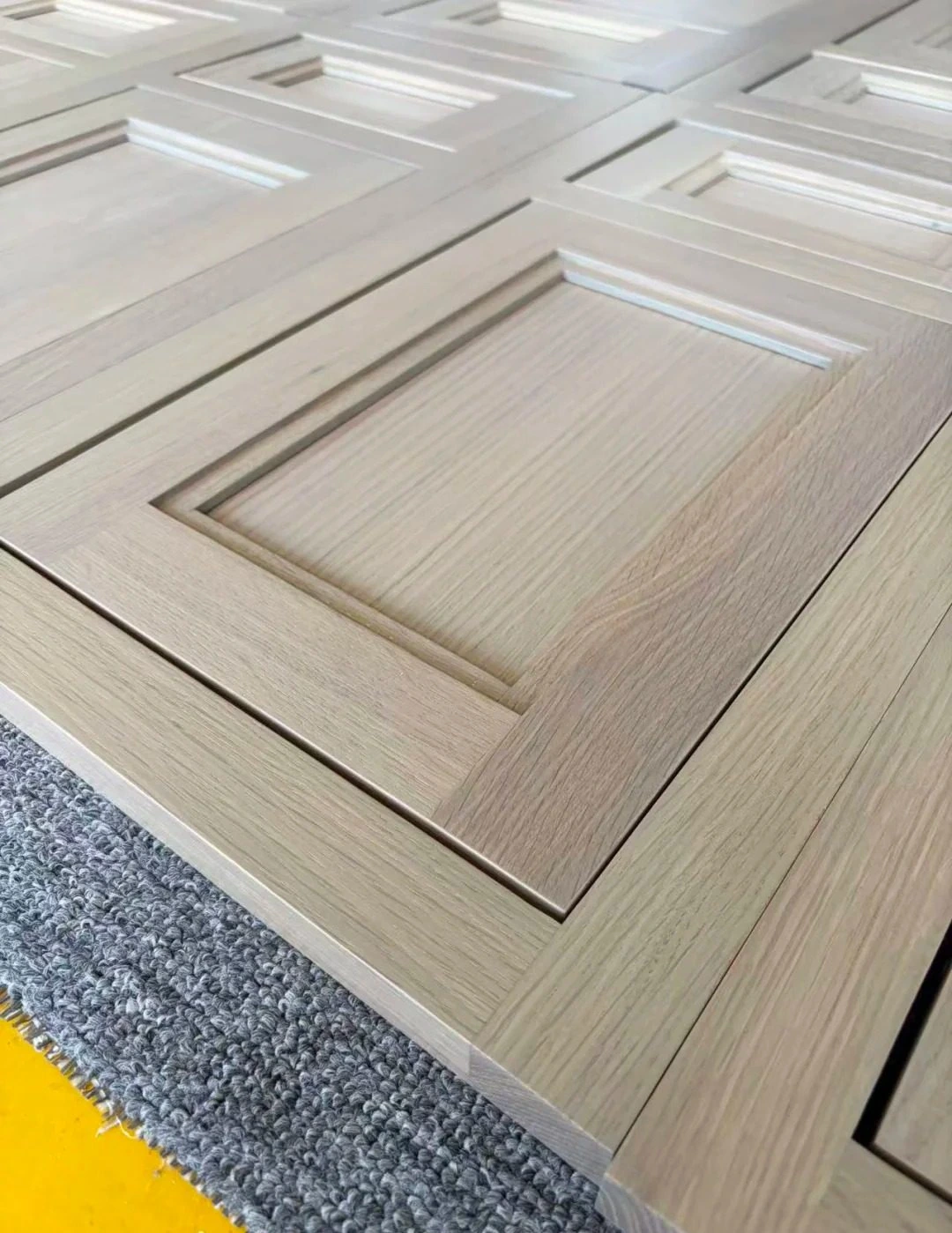 Semi-transparent oak cabinet panel showing natural grain under finish