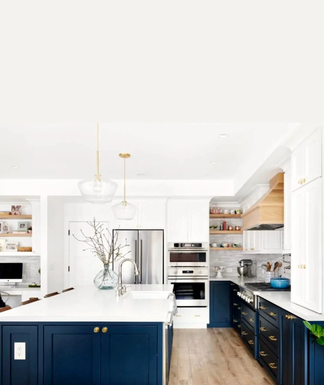 Completed kitchen cabinetry with white perimeter and blue island