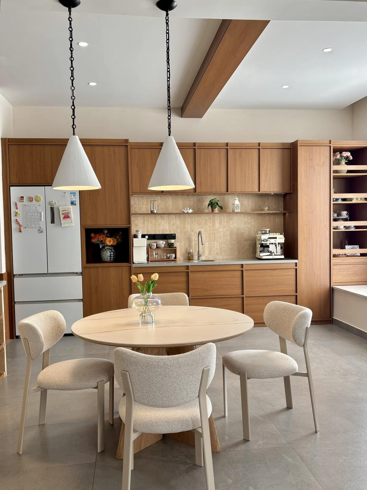 Dining area with coordinated wood cabinetry and furniture finishes