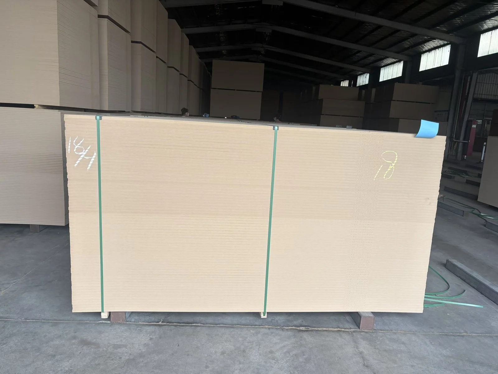Large batch of engineered wood panels stored in a furniture factory