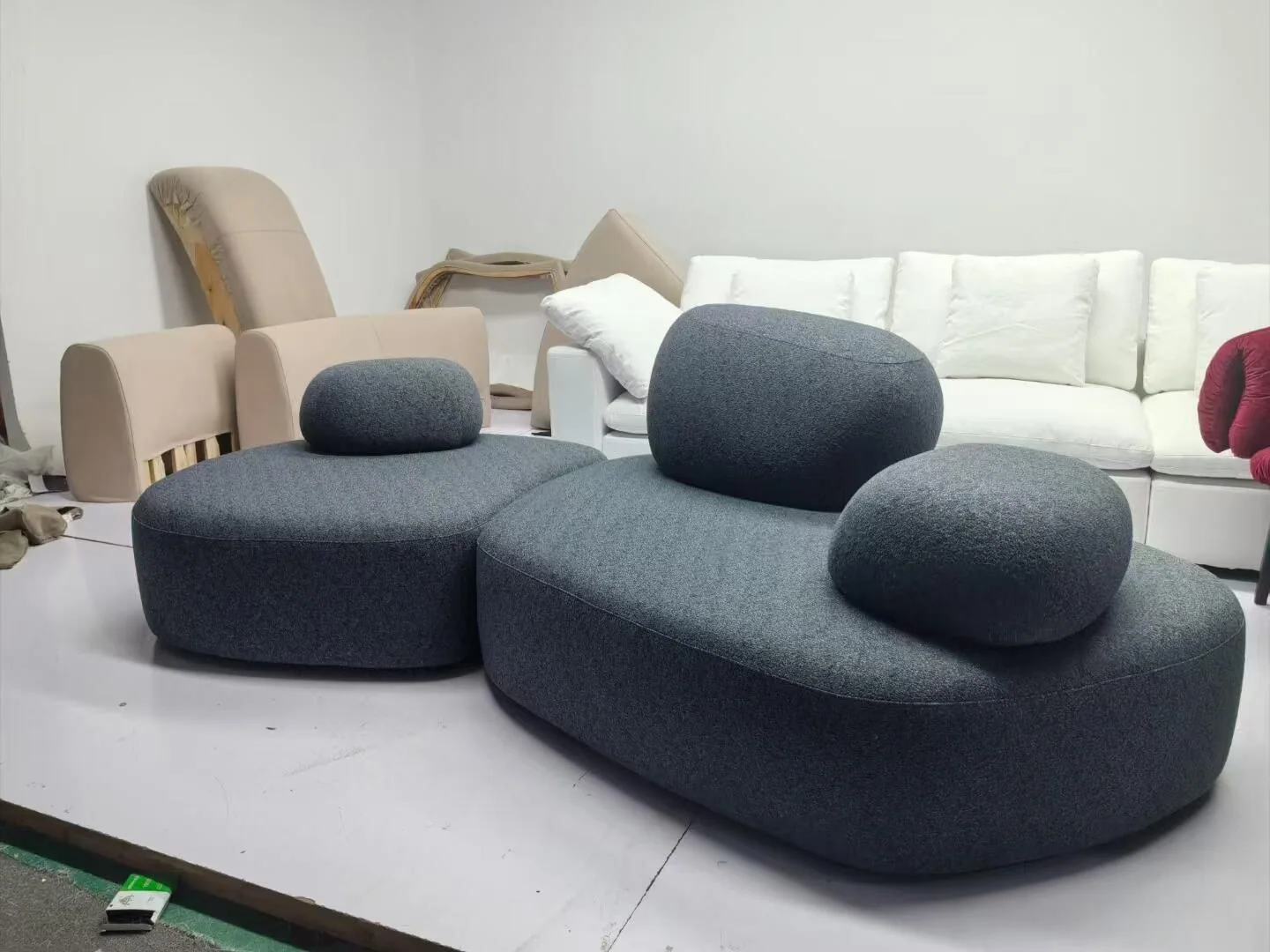 Dark gray sculptural sofa upholstered in a dense fabric