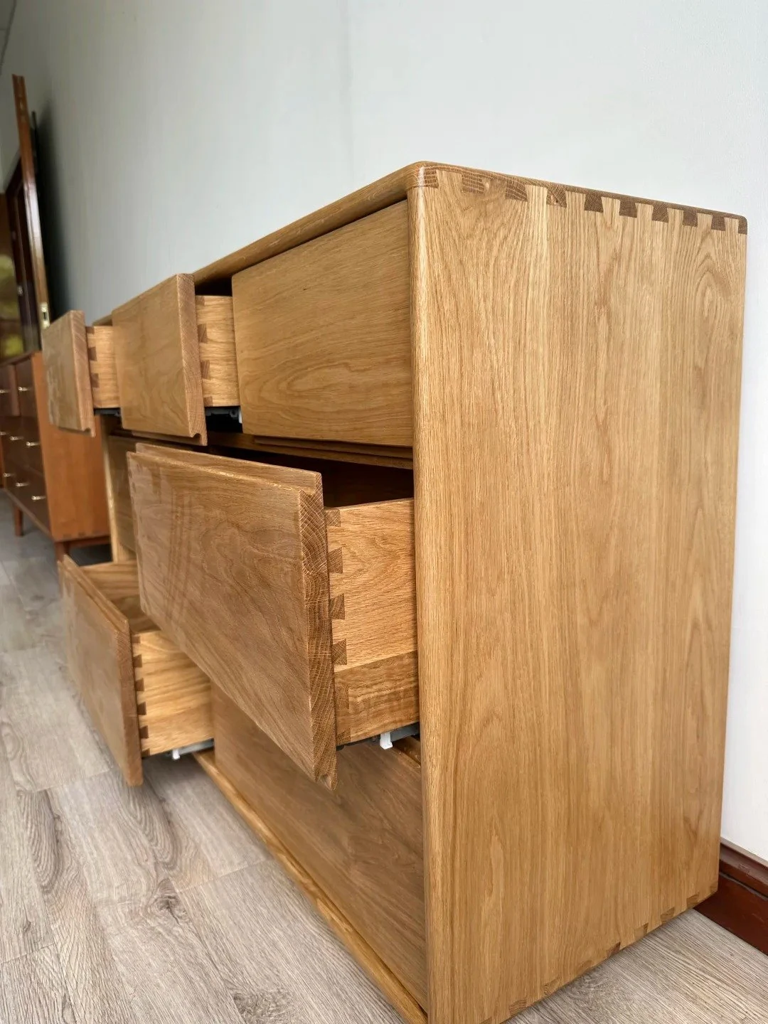 Open white-oak dresser showing dovetail drawer construction
