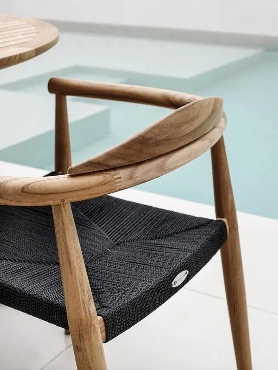 Finished solid-wood chair with shaped arms