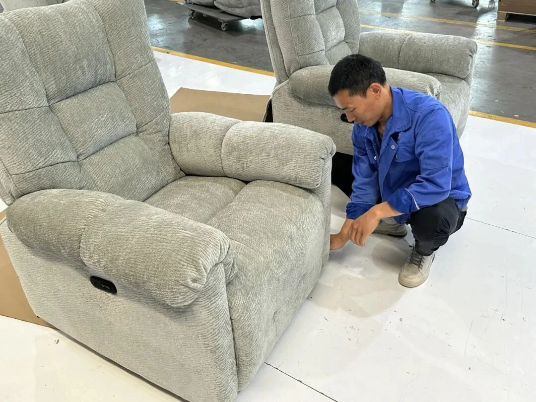 Factory worker checking sofa dimensions and trim
