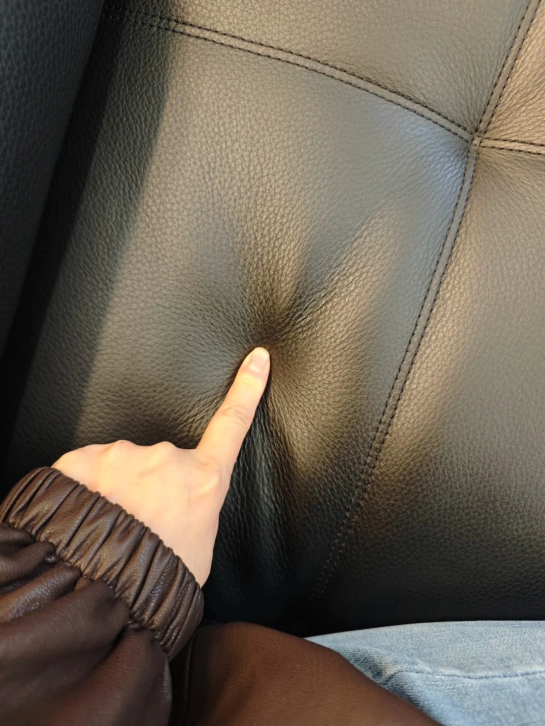 Hand checking upholstered sofa surface