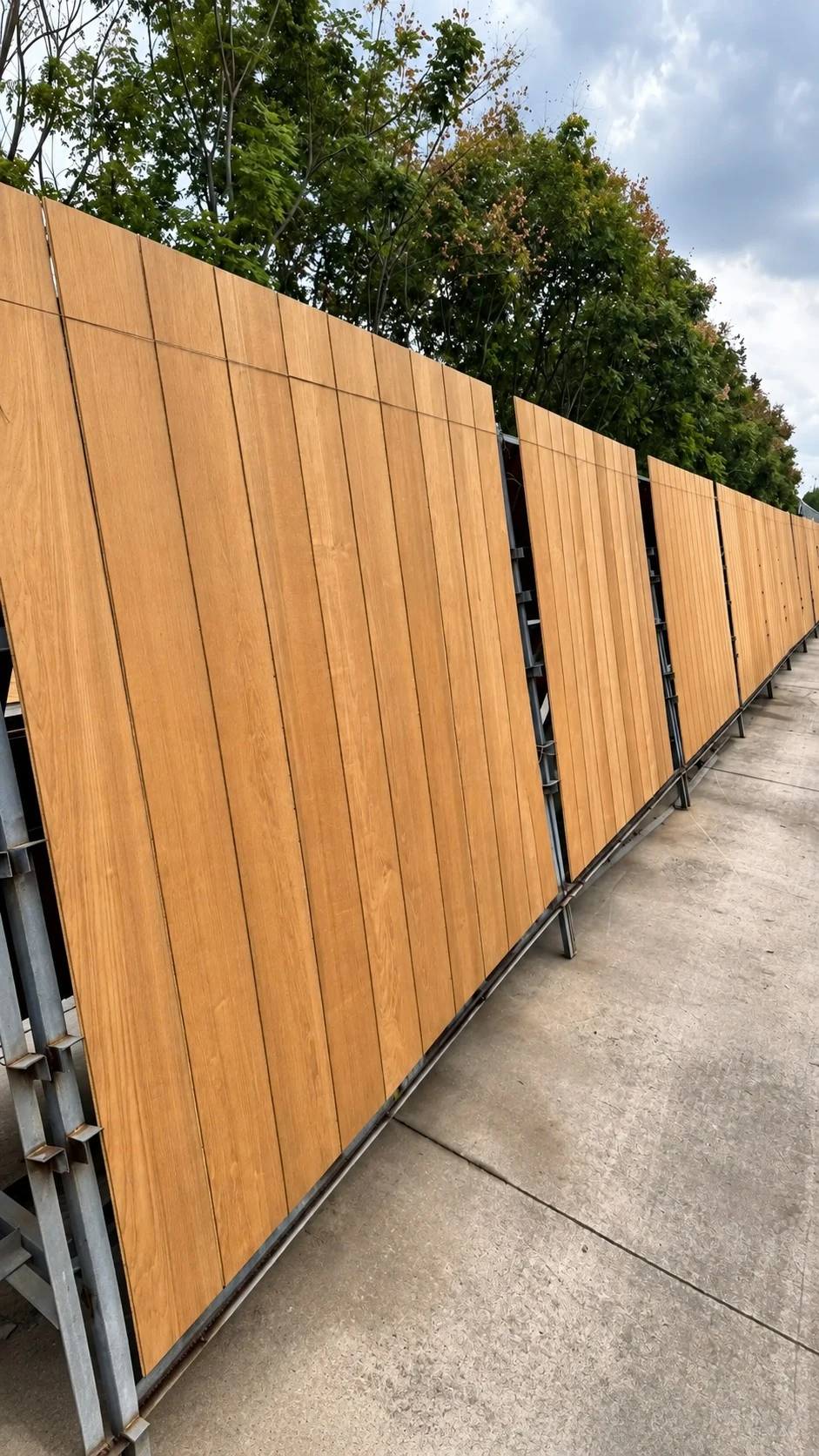 Solid wood boards drying outdoors in a long ventilated rack