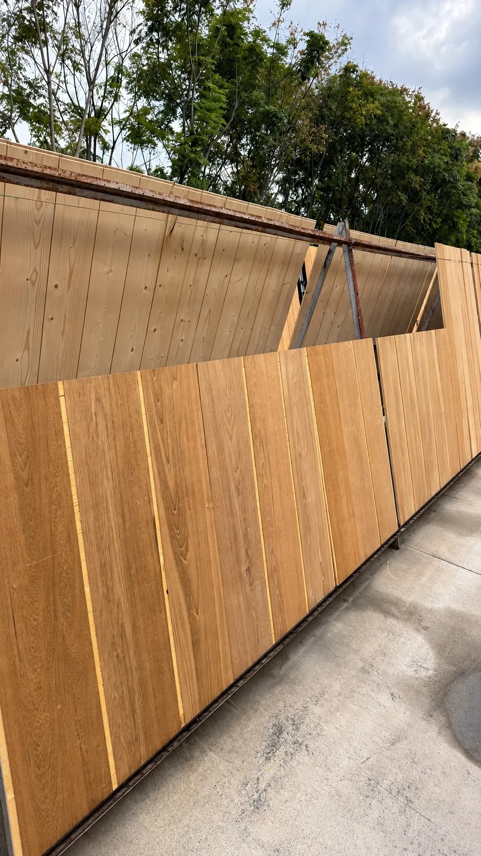 Wood boards being air dried against a ventilated rack