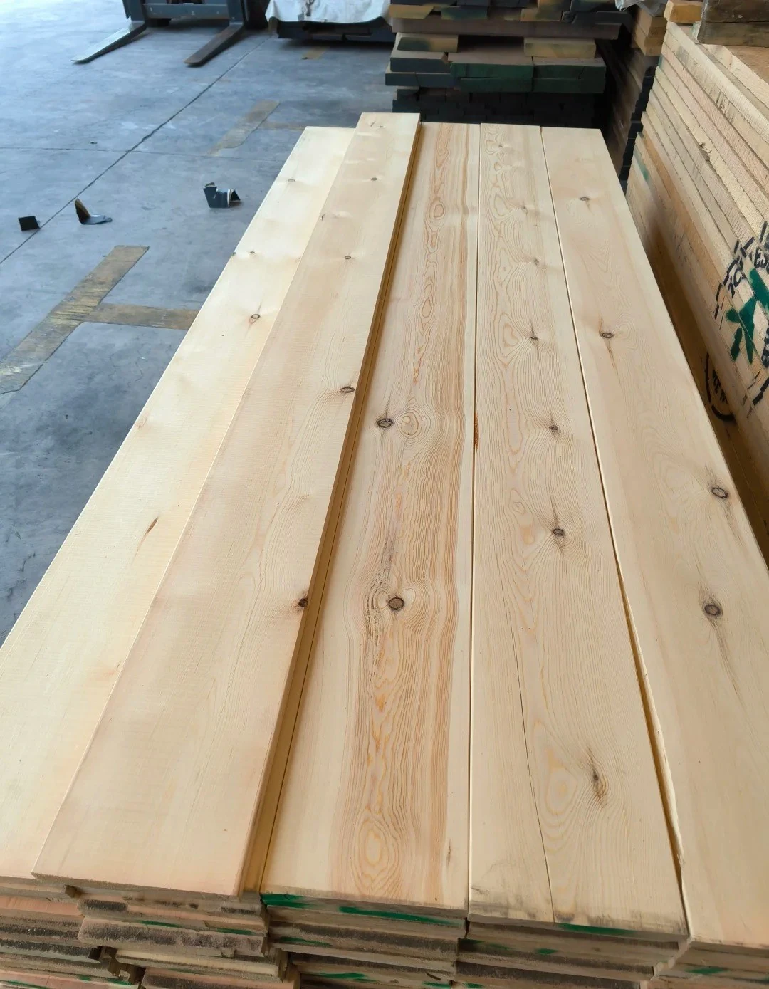 Long solid-wood boards awaiting inspection