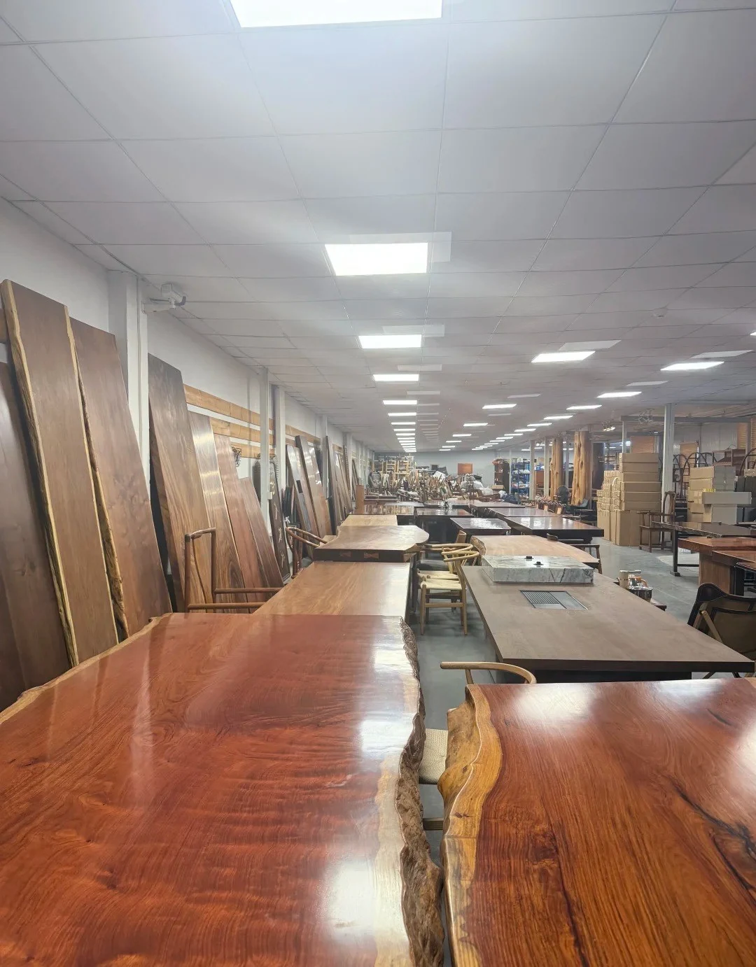 Wide solid-wood slabs inside a furniture workshop