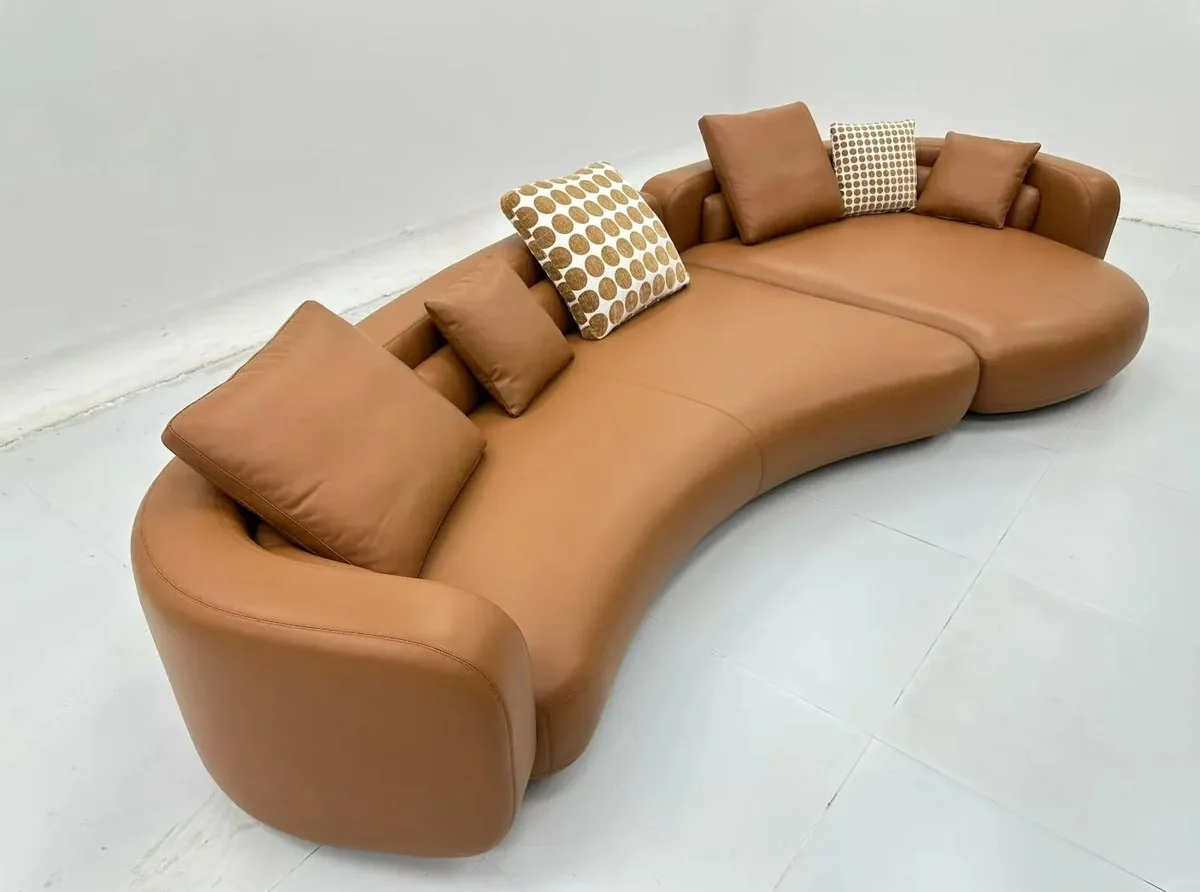 Curved camel sofa in studio