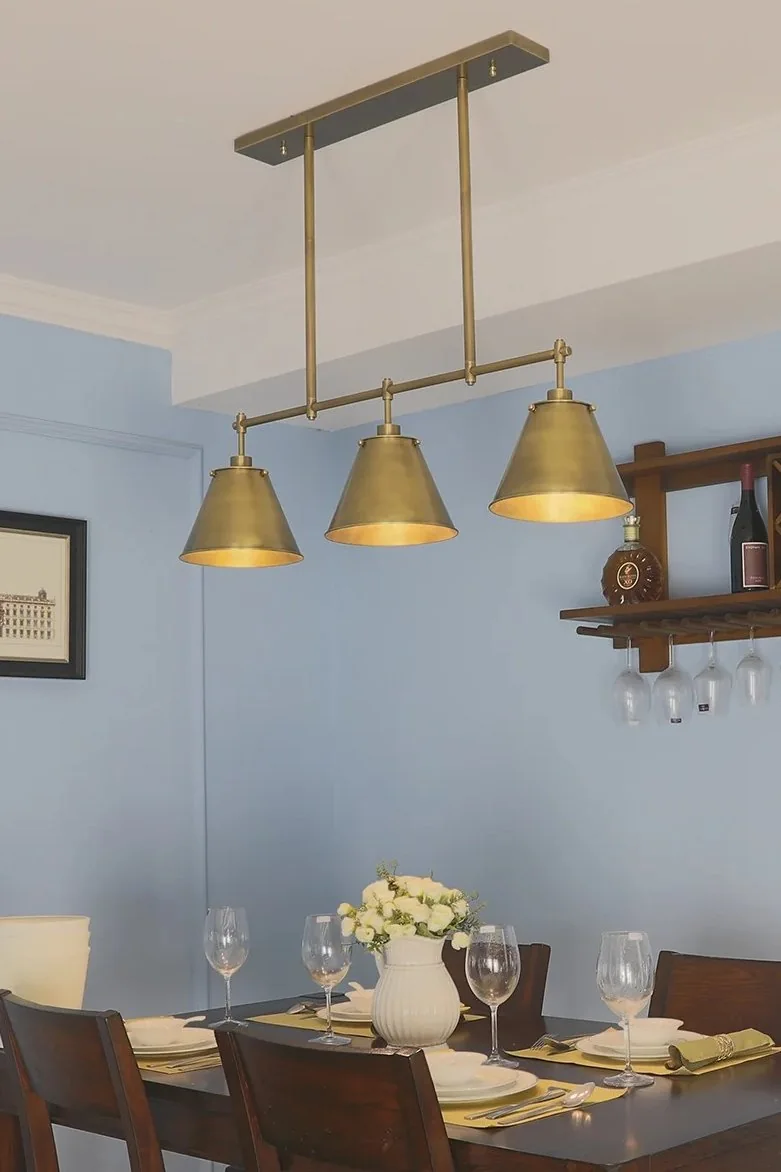 Brass lighting can act as an accent material that repeats hardware without dominating the furniture.